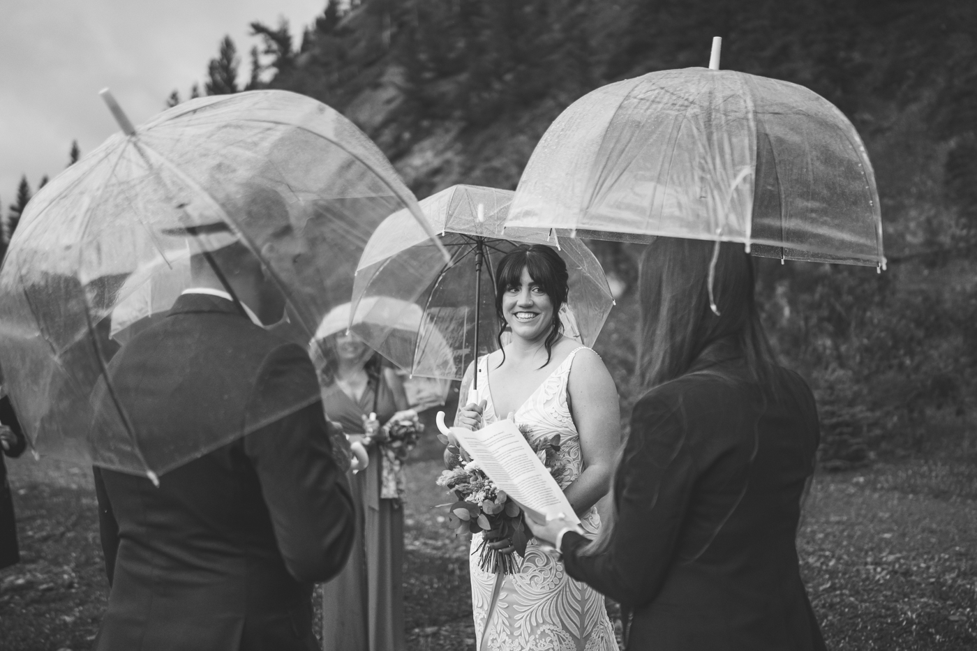 Bride and groom eloping in the mountains in the rain.