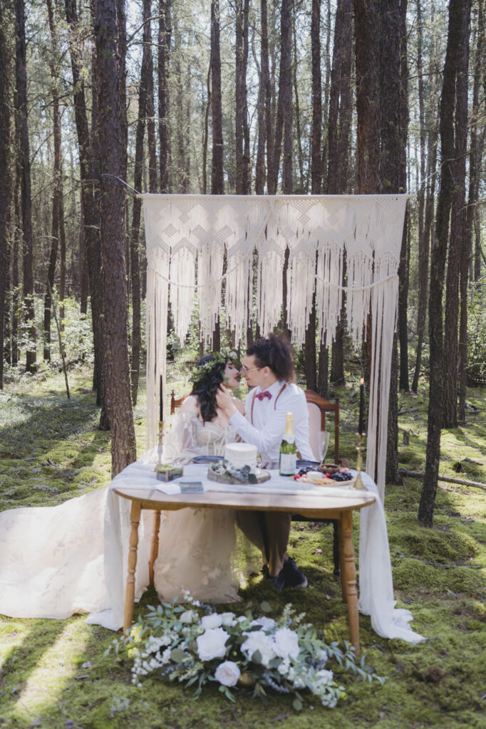 A boho bride and groom getting married in the forest.