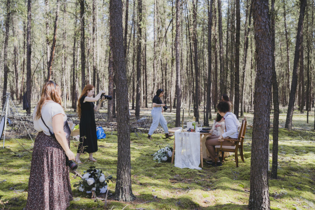 A boho bride and groom getting married in the forest during a photographer workshop. 
