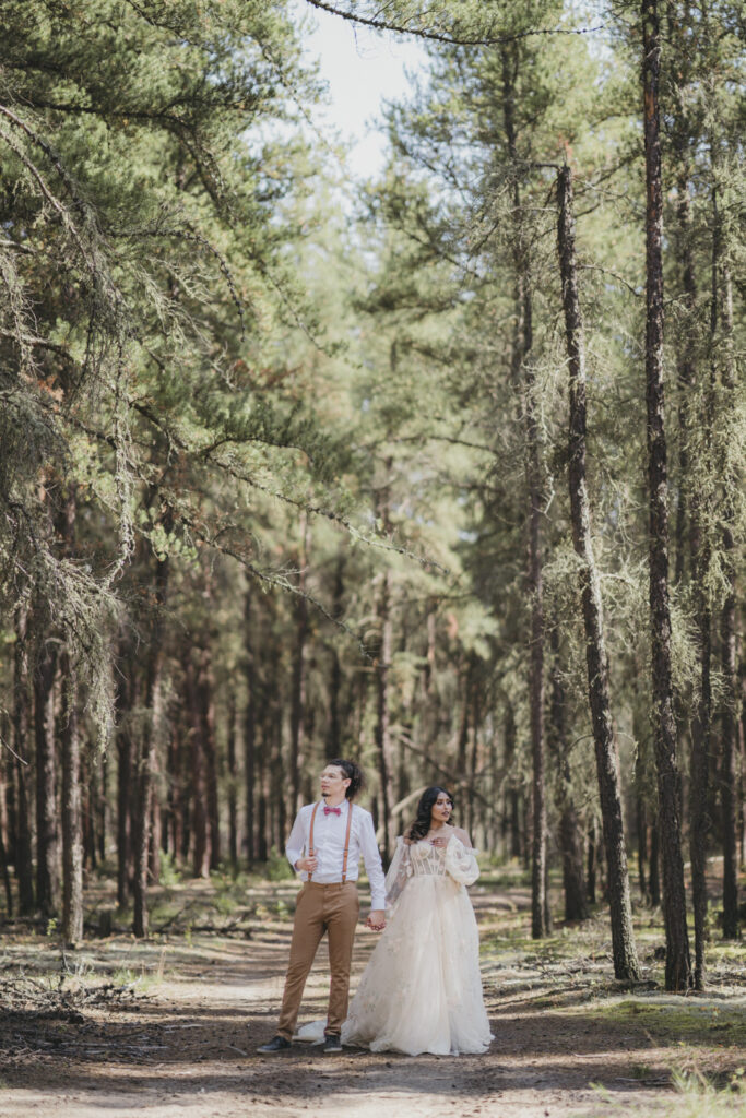 A boho bride and groom getting married in the forest.