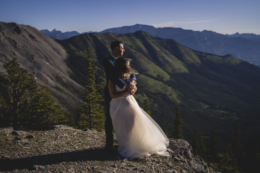 Bride and groom embracing during a mountain elopement with their canmore photographer. 