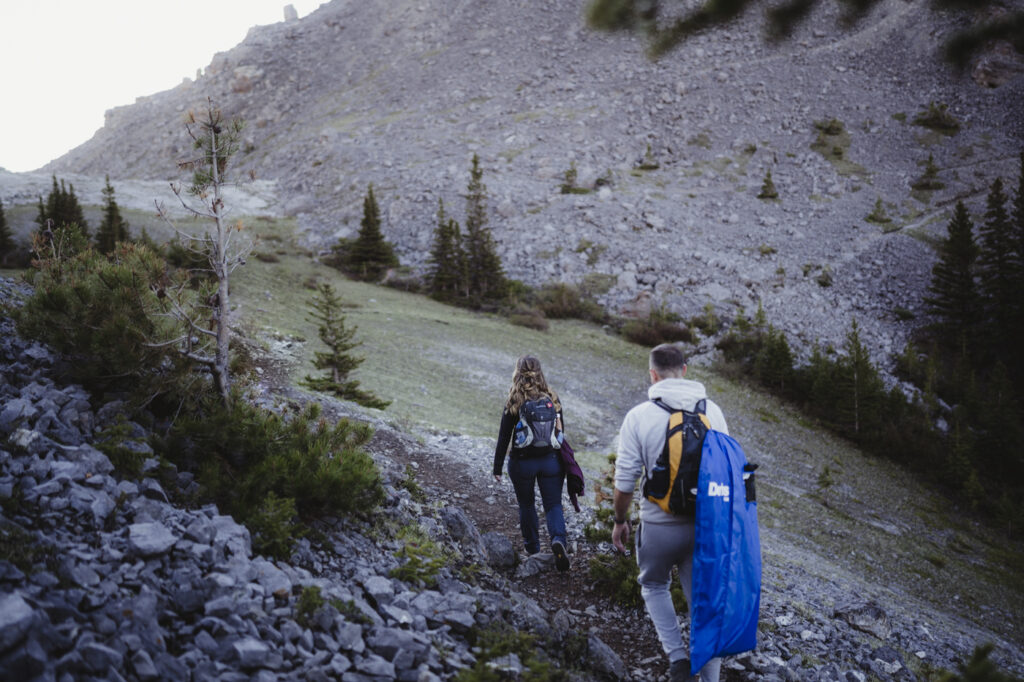 Bride and groom hiking up to their ceremony spot for their mountain elopement with their canmore photographer. 