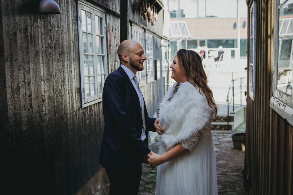 Elopement couples getting married in the cobblestone streets of the Faroe Islands. 