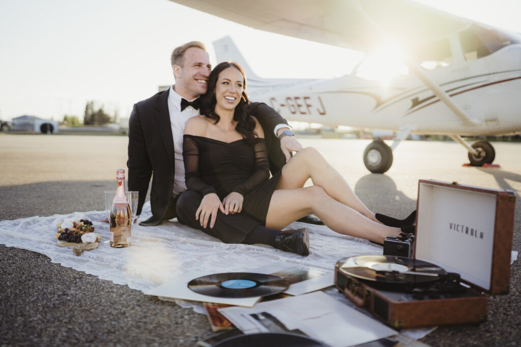Couple enjoying music and a charcuterie board during their photoshoot at Edmonton flight club. 