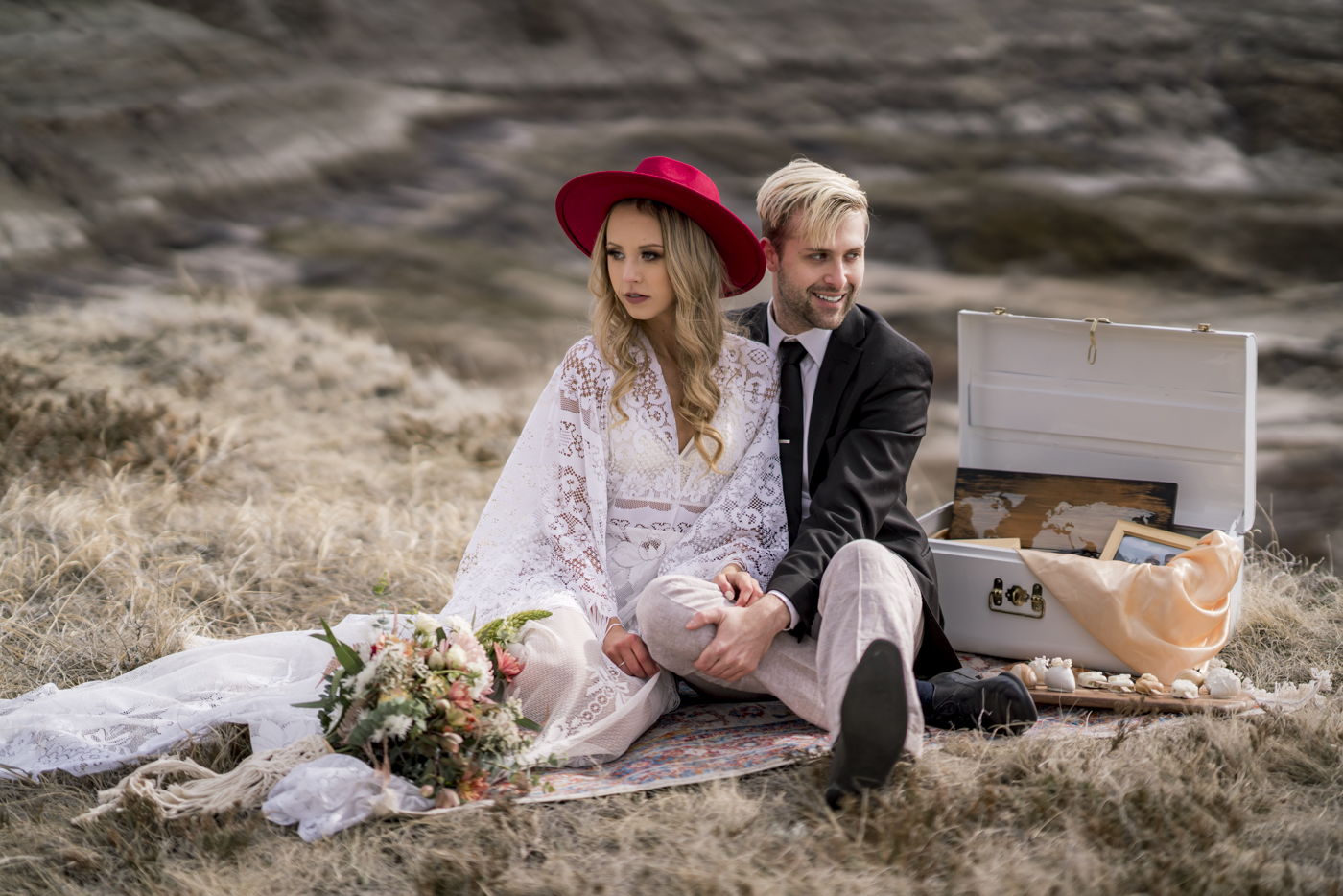 Elopement couple sitting on a vintage rug during their Drumheller Elopement.