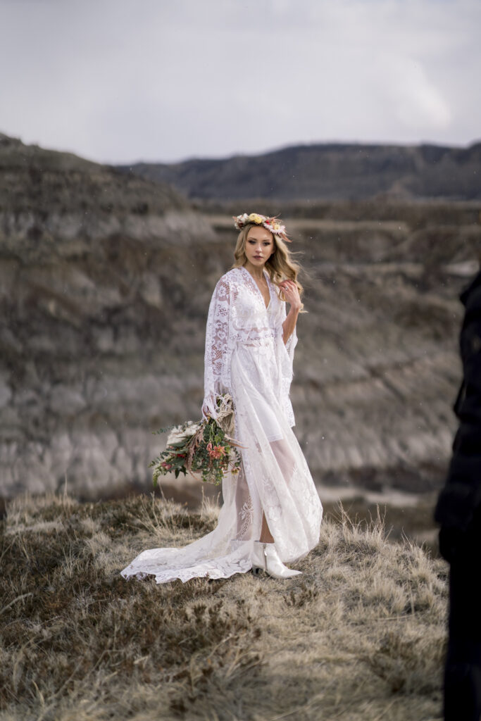 Beautiful bride standing on the edge of the badlands. 